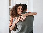 Happy, love and a couple hugging in their home for support, care or romance in marriage together. Smile, trust and security with a woman embracing her husband in their house for relationship bonding