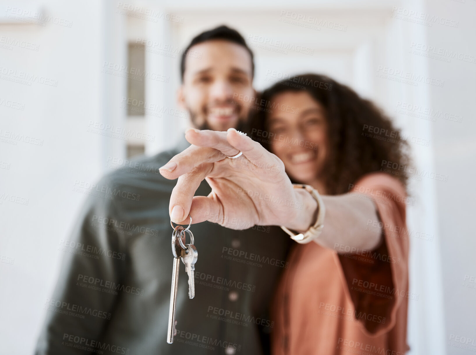 Buy stock photo Hand, house keys and couple face for real estate, success or mortgage goal together. New home, property and portrait of man with woman smile for investment, dream or financial security in living room