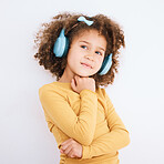 Music, headphones and kid thinking in studio isolated on a white background mockup space. Idea, radio and girl child listening to podcast, streaming audio and hearing media sound online on technology