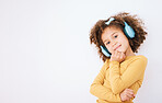 Girl child, portrait and headphones and listening to music with smile isolated on white background. Technology, audio streaming and podcast, mockup space and kid with playlist and radio in studio