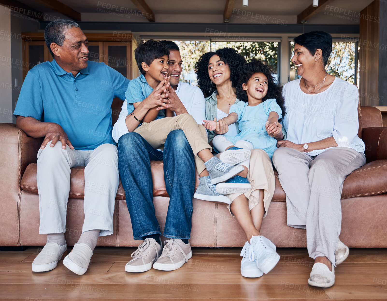 Buy stock photo Smile, funny and relax with big family on sofa for happy, bonding and peace. Love, generations and grandparents with parents and children in living room at home for vacation, cuddle and embrace