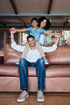 Buy stock photo Smile, airplane and portrait with family on sofa for happy, bonding or peace on holiday. Love, care and playful with parents and child in living room at home for vacation, cuddle and embrace together