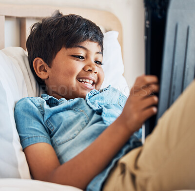 Buy stock photo Happy, cartoon and a child with a tablet in the bedroom for movie, film or streaming games. Smile, relax and a boy kid with technology in a house for the internet, online reading or playing on an app