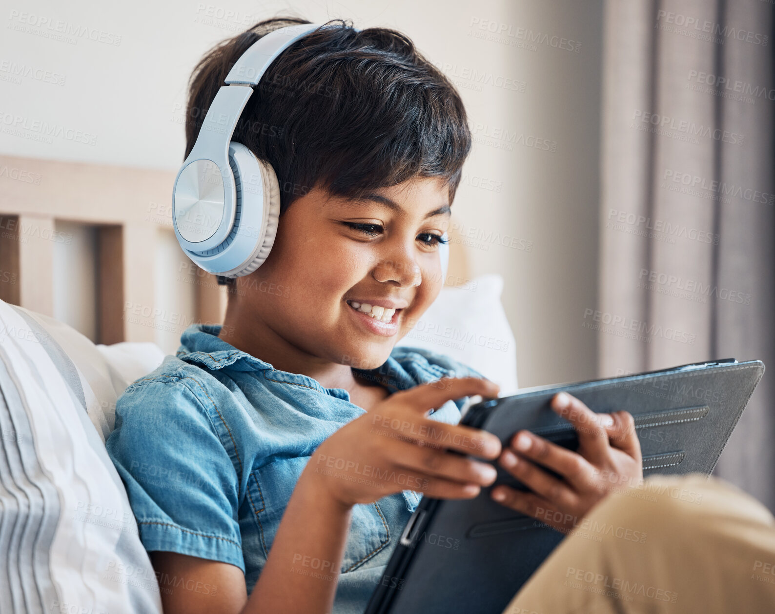 Buy stock photo Happy, kid and headphones with tablet in bedroom to watch movies, video game and elearning app. Boy child smile with digital technology for multimedia, listening to music or streaming cartoon at home