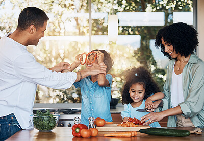 Buy stock photo Cooking, health and funny with family in kitchen for learning, food and nutrition. Wellness, support and vegetable with parents and children at home for meal prep, support and dinner together