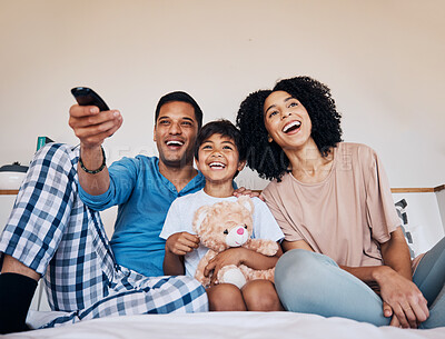 Buy stock photo Smile, morning and family watching tv in a bedroom of their home together for streaming or entertainment. Parents, children or a boy laughing on the bed with his mother and father to enjoy television