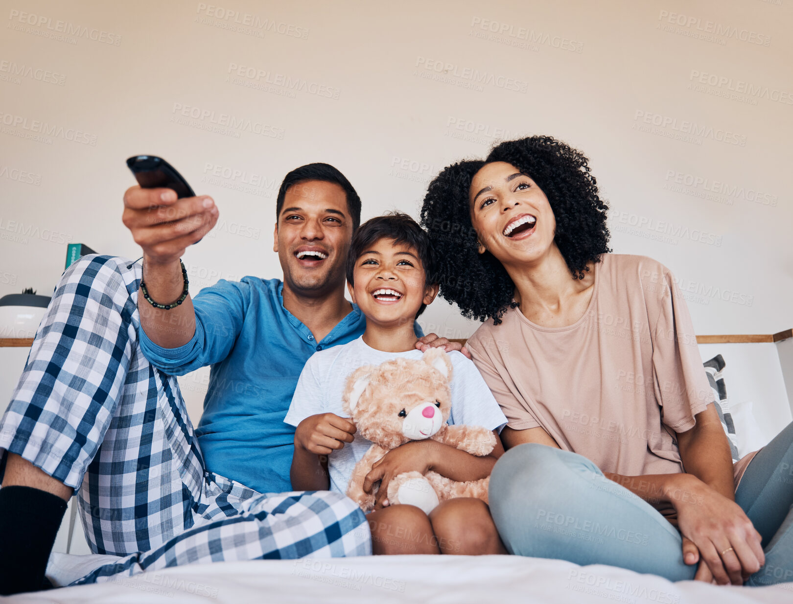 Buy stock photo Smile, morning and family watching tv in a bedroom of their home together for streaming or entertainment. Parents, children or a boy laughing on the bed with his mother and father to enjoy television