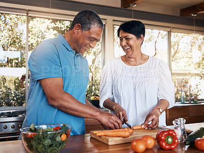 Buy stock photo Mature, couple and healthy cooking in kitchen to chop vegetables for salad diet, nutrition and lunch meal at home. Happy man, woman and help cut carrot ingredients for love, care and support together