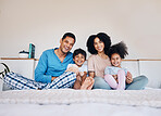 Happy, smile and portrait of a family on a bed together for bonding or connection at home. Happiness, excited and young children with their parents from Colombia in the room of their modern house.