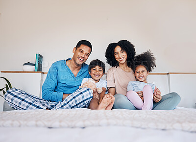 Buy stock photo Happy, smile and portrait of a family on a bed together for bonding or connection at home. Happiness, excited and young children with their parents from Colombia in the room of their modern house.