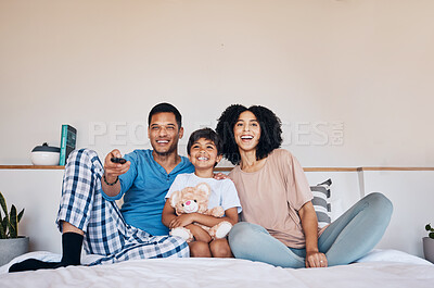 Buy stock photo Smile, morning and a family watching tv on bed in their home together for streaming or entertainment. Parents, children or a boy in the bedroom with his mother and father to enjoy a television movie