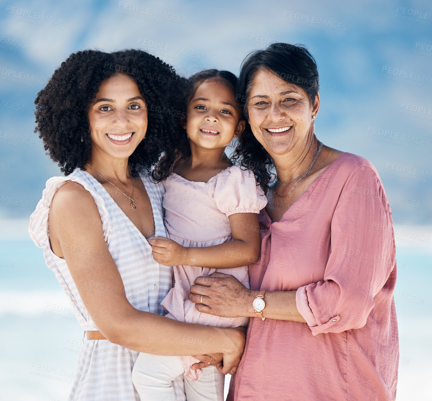 Buy stock photo Mom, grandma and girl in beach portrait, smile and hug with care, love and generations on vacation in sunshine. Mature woman, happy mother and daughter for bonding, summer and holiday together by sea