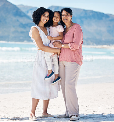 Buy stock photo Beach, portrait and happy family hug in nature with freedom, fun and bonding at the ocean. Love, smile and girl child with mother, grandmother and embrace at sea for summer vacation, trip or holiday