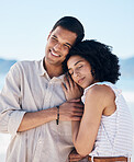 Beach, hug and couple with love, vacation and travel with romance, marriage and relationship. Romantic, man and woman embrace, seaside holiday and care with adventure, bonding and loving together