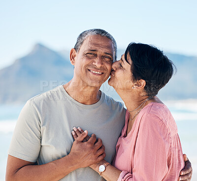 Buy stock photo Kiss, love and mature couple outdoor at beach with a smile, care and happiness together in nature. Portrait of a happy man and woman for healthy marriage, kindness and anniversary on a travel holiday