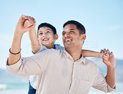 Buy stock photo Happy, beach and father doing airplane with child having fun on family vacation or holiday. Happiness, smile and young dad playing with his boy kid by the ocean on adventure or weekend trip together.