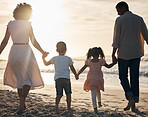 Sunset, beach and back of family holding hands in nature for travel, bond and fun together. Rear view, love and children with parents at the ocean for sunrise walk, relax and enjoy freedom in Mexico