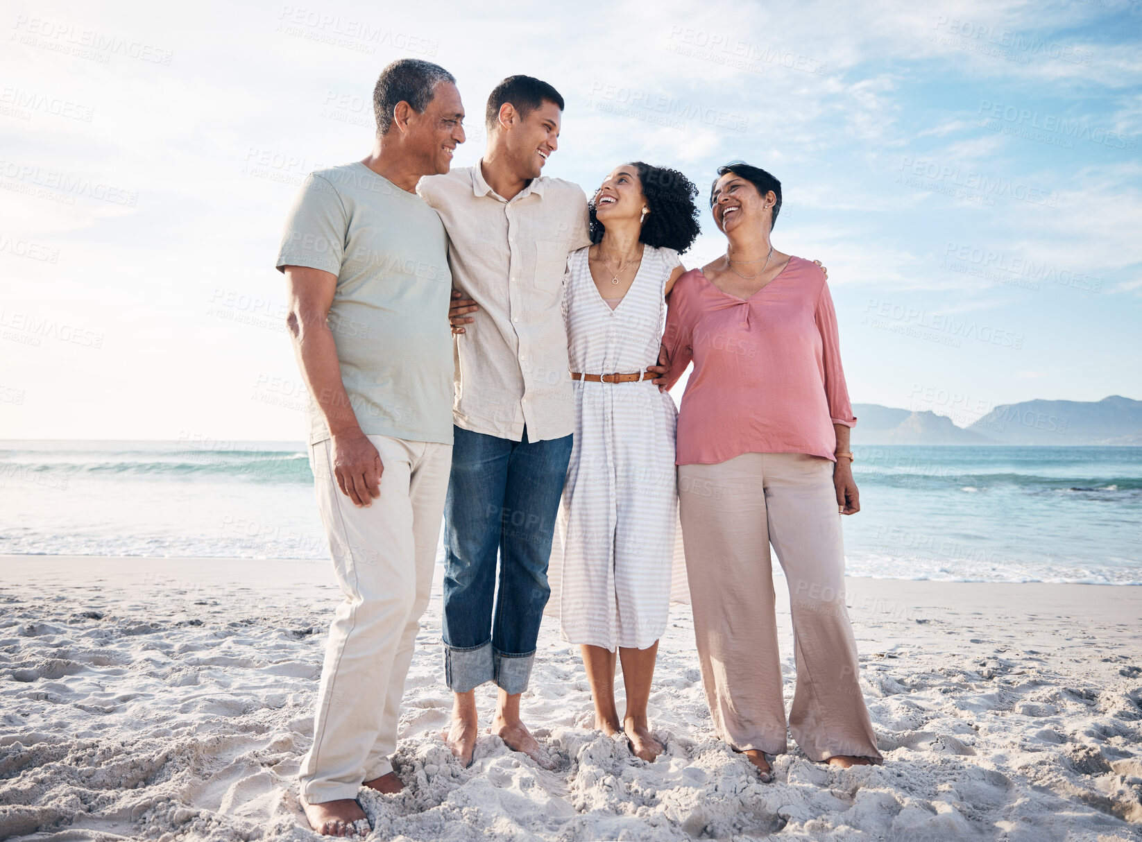 Buy stock photo Sea, senior parents and adult children together with smile, love and hug on summer holiday in Mexico. Embrace, happy family support and mature mother, father and generations on beach vacation travel.