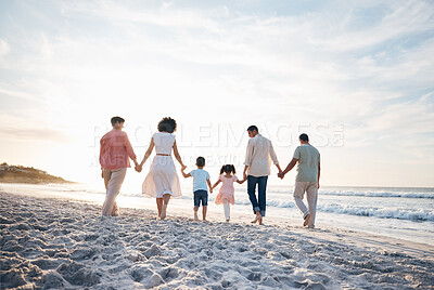 Buy stock photo Holding hands, walking and back of big family at the beach for travel, vacation and adventure in nature. Love, freedom and rear view of children with parents and grandparent at sea for ocean journey