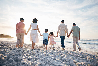 Buy stock photo Walking, holding hands and back of big family at the beach for travel, vacation and adventure in nature. Love, freedom and rear view of children with parents and grandparent at sea for ocean journey