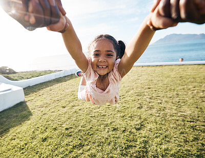 Buy stock photo Girl, spin and outdoor portrait in pov, holding hands or happy for game with parent, holiday or backyard. Female child, smile and swing in air, fast or excited for play on vacation in summer sunshine