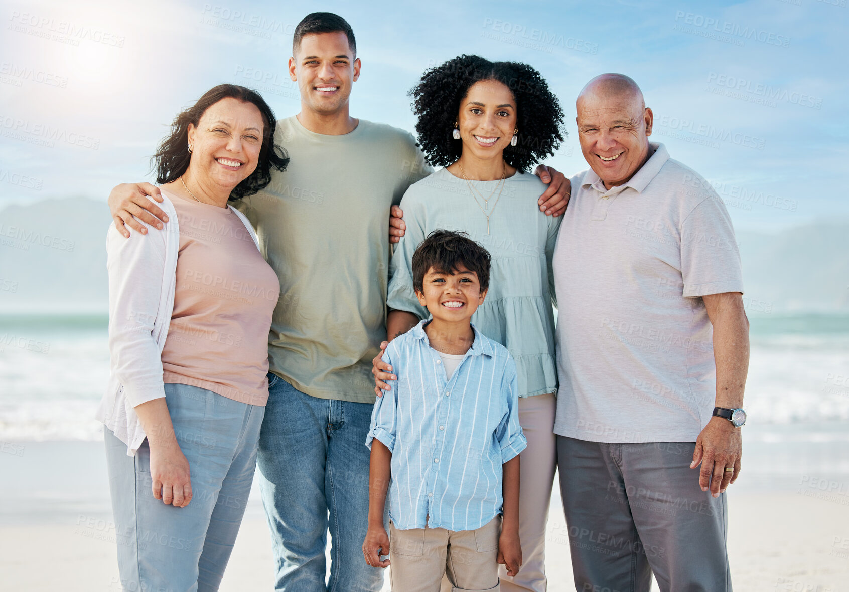 Buy stock photo Portrait, grandparents and a family on the beach in summer together for holiday or vacation by the ocean. Love, nature or freedom with parents and children at the sea for bonding or weekend travel