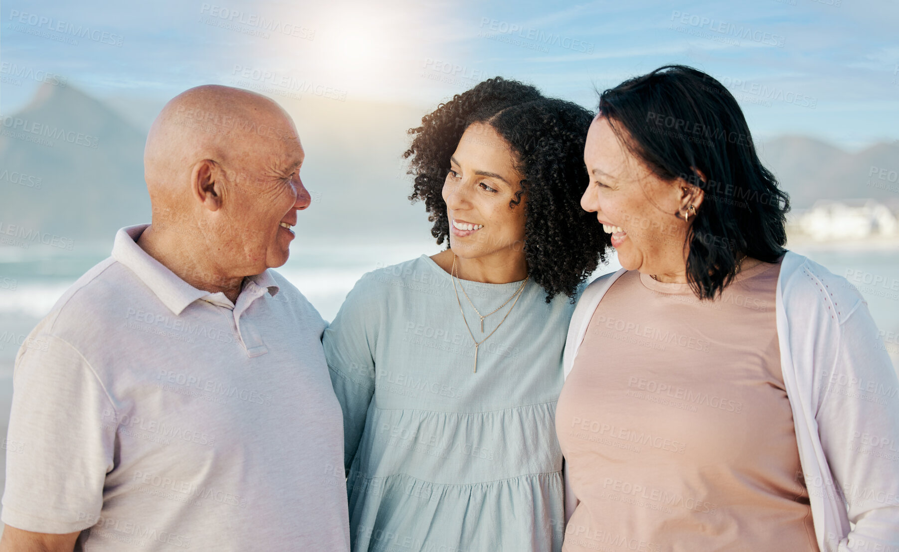 Buy stock photo Happy, beach and woman with her senior parents on a family vacation, holiday or adventure. Love, smile and young female person talking to her elderly mother and father by the ocean on a weekend trip.