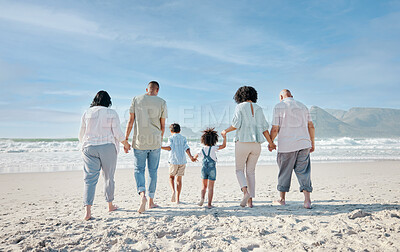 Buy stock photo Family, holding hands and relax outdoor on a beach with love, care and happiness for summer vacation. Behind, space in sky or travel with men, women and children together at sea for holiday adventure