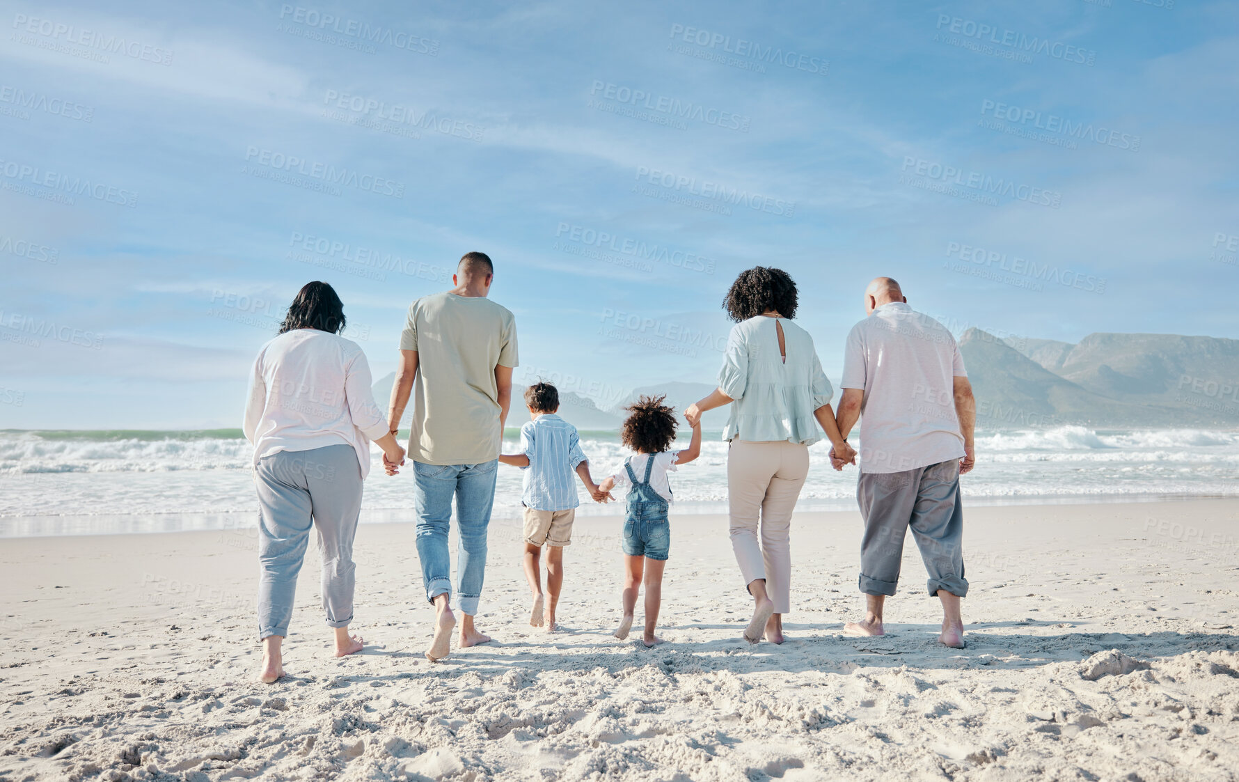 Buy stock photo Family, holding hands and relax outdoor on a beach with love, care and happiness for summer vacation. Behind, space in sky or travel with men, women and children together at sea for holiday adventure