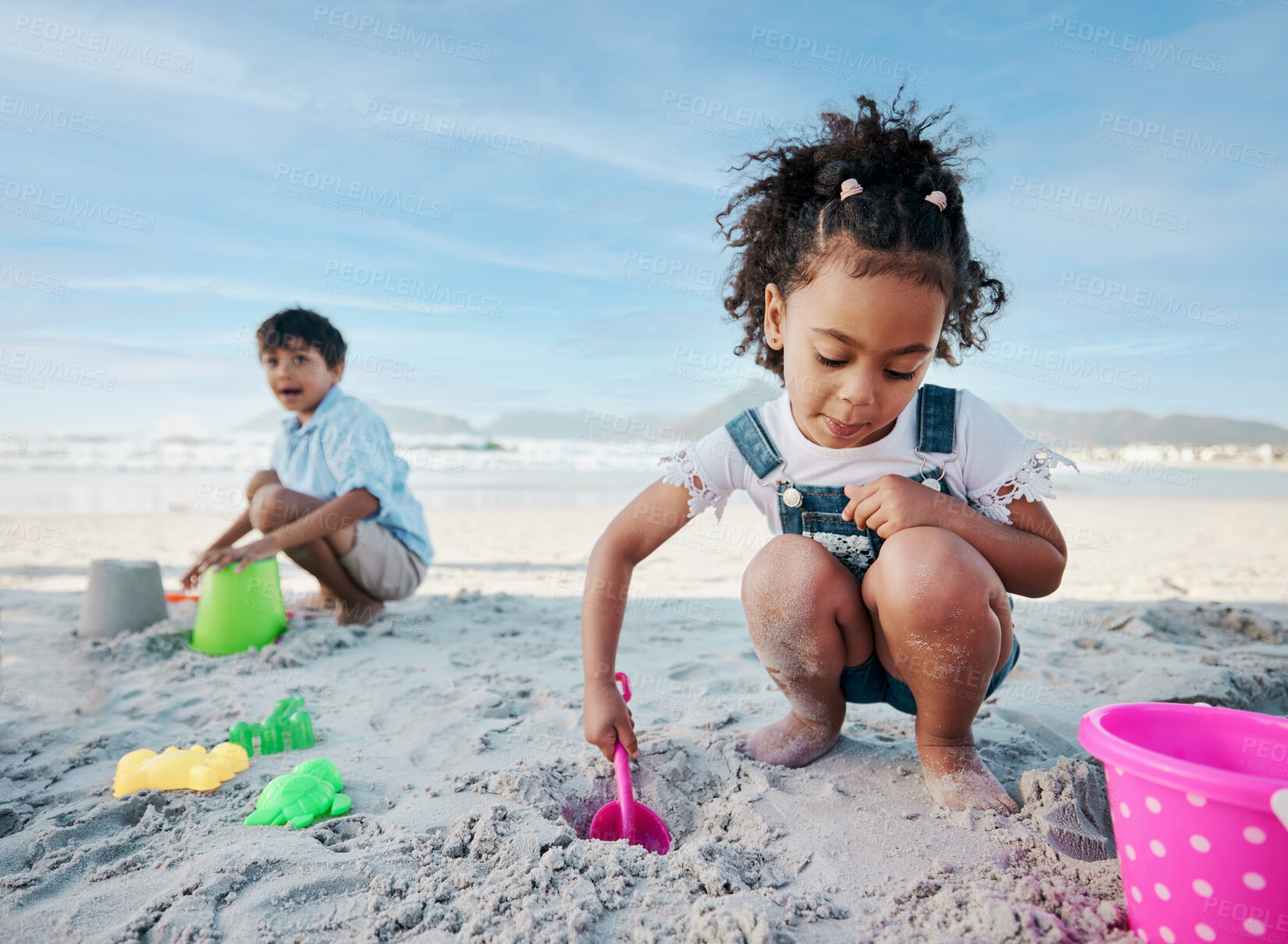 Buy stock photo Boy, girl and shovel with bucket, beach and digging sand with playing, outdoor and vacation in summer. Kids, siblings and plastic toys for sandcastle, construction game and happy for holiday by ocean