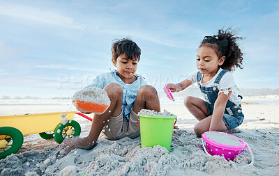 Buy stock photo Boy, girl and shovel with bucket, beach sand and digging for  playing, outdoor and vacation in summer. Kids, siblings and plastic toys for sandcastle, construction game and together on holiday by sea