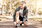 Senior man, tie shoelace and running, fitness and cardio in the park, start and health, wellness and vitality. Runner is ready for exercise, athlete and sports with sneakers, path outdoor and active