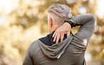Back pain, fitness and man in exercise injury, sports risk or muscle massage, outdoor or nature. Stretching, spine and senior person stress, tired and training, cardio or workout accident in forest