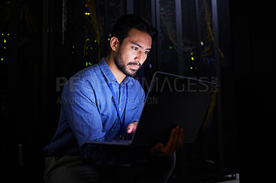 Buy stock photo Night, server room or man typing for cybersecurity glitch, machine or internet servers system. IT support, data center or Asian engineer fixing network for information technology solution or research