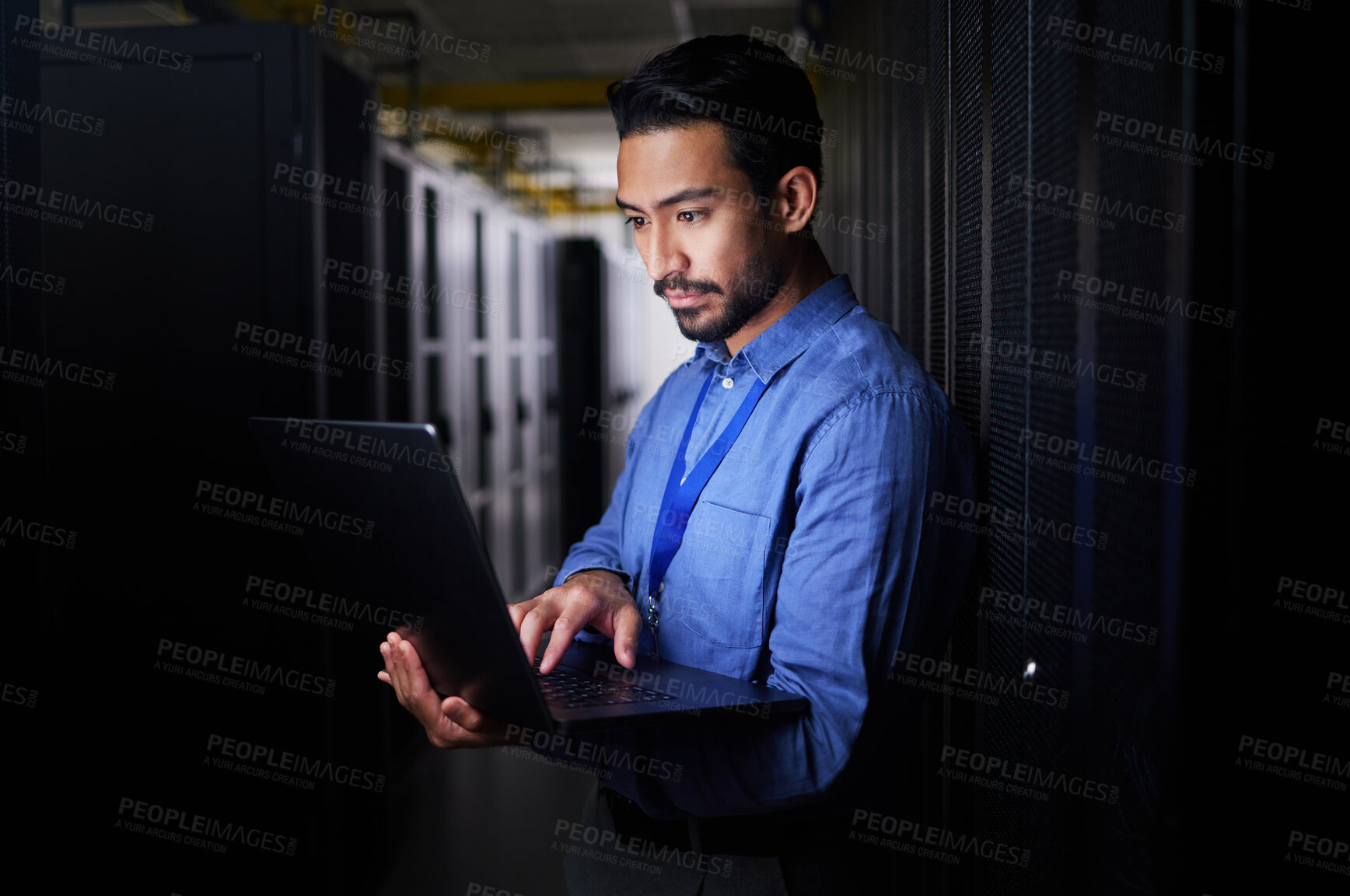Buy stock photo Man, server room and laptop of programming, system management and data center solution or coding at night. Business person engineering on computer, information technology and power check in basement