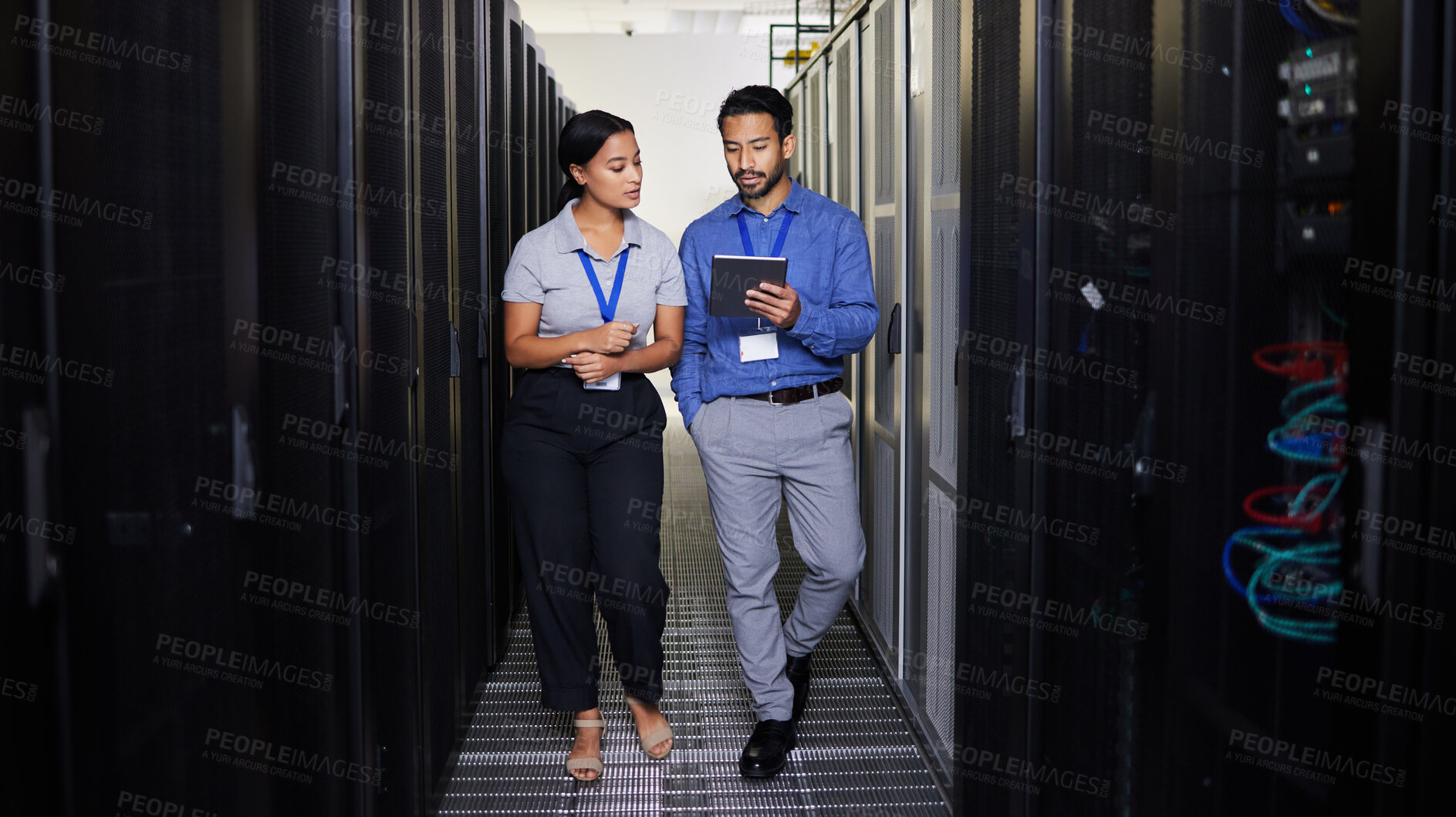 Buy stock photo People, server room and teamwork on tablet, cybersecurity, engineering and programming or coding solution. Engineering man and woman or manager walking in data center, digital technology and training