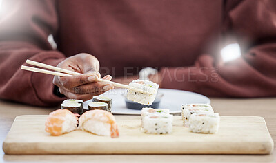 Buy stock photo Sushi, seafood and health with hands of person in store for brunch, Japanese cuisine and menu. Fish, salmon and restaurant with closeup of customer eating for nutrition, Asian diet and fine dining