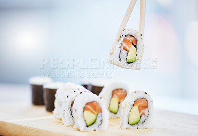 Buy stock photo Sushi, closeup and food with fish for eating, salmon and rice with avocado, healthy and fine dining. Japanese cuisine, catering with lunch or dinner meal, chopsticks and gourmet seafood for nutrition