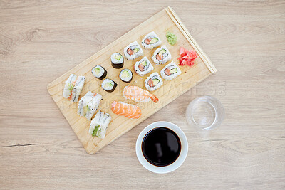 Buy stock photo Sushi, top view and soy sauce with seafood on wood board, closeup with salmon and rice, healthy and luxury. Japanese cuisine, catering with lunch or dinner meal, chopsticks and food with nutrition