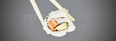 Buy stock photo Seafood, sushi and chopsticks in studio, salmon roll isolated for healthy Asian dining promo. Japanese food culture with rice, raw fish and avocado, restaurant menu offer or deal on grey background.