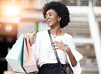 Black woman, shopping bag and happy customer walking outdoor in a city for retail deal, sale or promotion. African person with and smile and excited about buying fashion product on urban travel