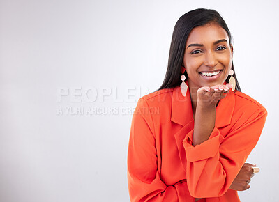 Buy stock photo Smile, portrait and Indian woman blowing kiss in studio for flirting, care or romance gesture on grey background. Happy, face and female model with hand kissing emoji for thank you, gratitude or love