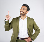 Businessman, thinking and man pointing for promotion, deal and logo isolated in a studio white background with smile. Choice, corporate and happy person or employee showing advertising or news