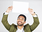 Happy asian man, billboard and sign for advertising, marketing or branding against a white studio background. Businessman smile with paper, poster or idea for message or advertisement on mockup space