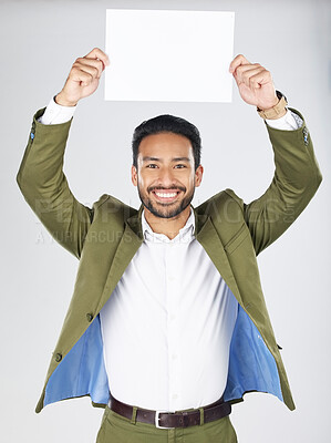 Buy stock photo Happy asian man, portrait and billboard in advertising, marketing or branding against a white studio background. Businessman smile with paper, poster or sign for message or advertisement on mockup
