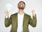 Money, winner and man with fist celebration in studio for payment, loan or cashback on grey background. Cash, award and Japanese male celebrating investment, growth or financial freedom bingo prize