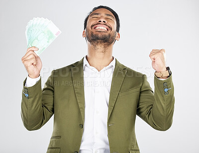 Buy stock photo Money, winner and man with fist celebration in studio for payment, loan or cashback on grey background. Cash, award and Japanese male celebrating investment, growth or financial freedom bingo prize