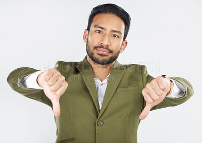 Buy stock photo Portrait, thumbs down and man in studio for wrong, vote or disagreement sign on white background. Face, rejection and Mexican male with emoji hand vote for fail, feedback or opinion, choice or review