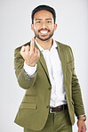 Business man, middle finger and studio portrait with anger, rude and frustrated by white background. Indian entrepreneur, smile and emoji for sign language, vote and opinion with hand for conflict