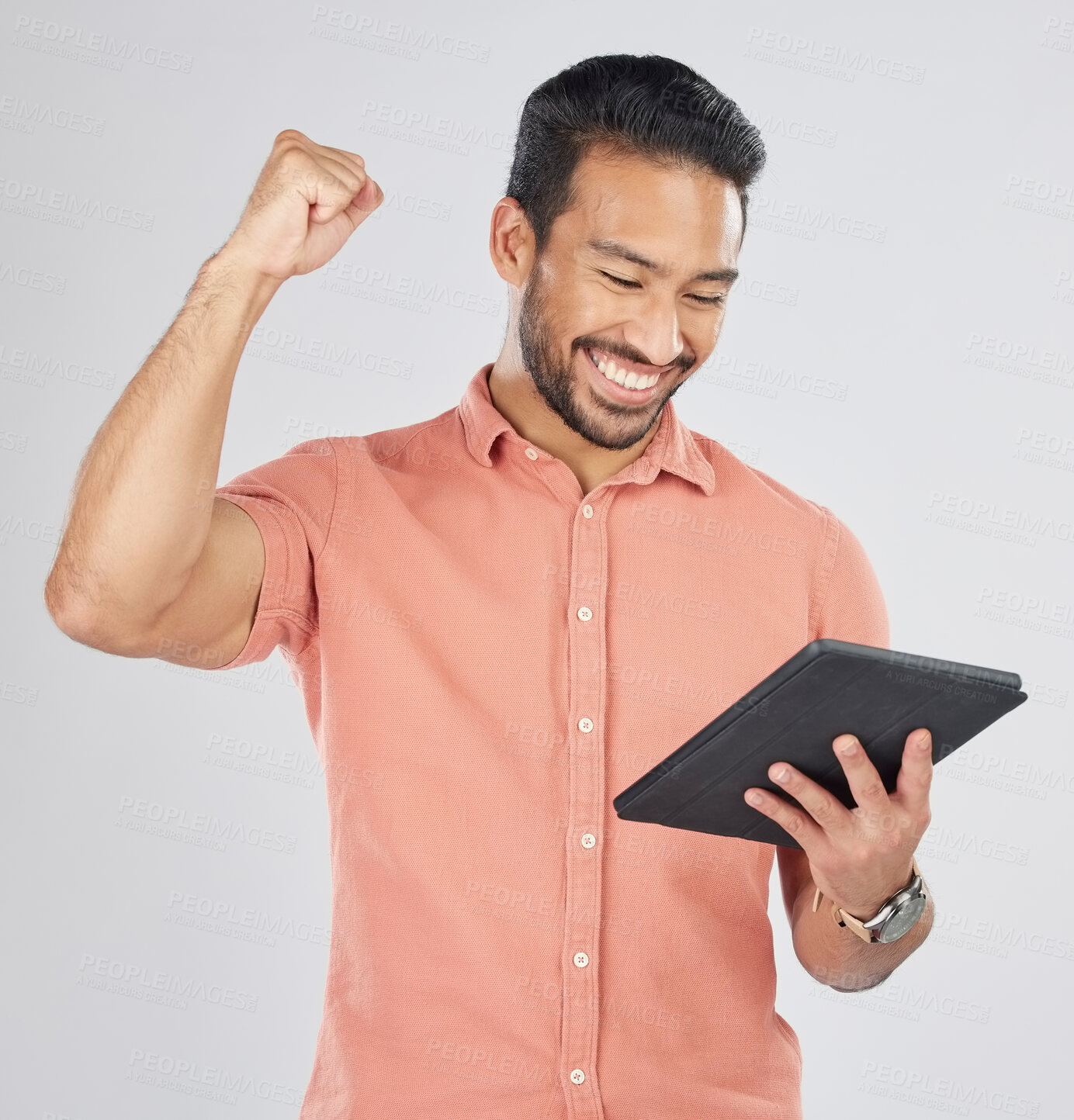 Buy stock photo Happy asian man, tablet and fist pump in winning, celebration or promotion against a white studio background. Excited male person with technology app in happiness for victory, success or good news